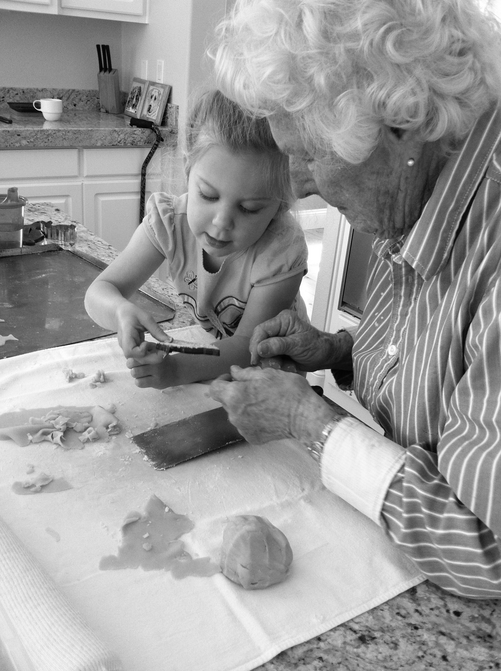 Grandmother and granddaughter baking cookies